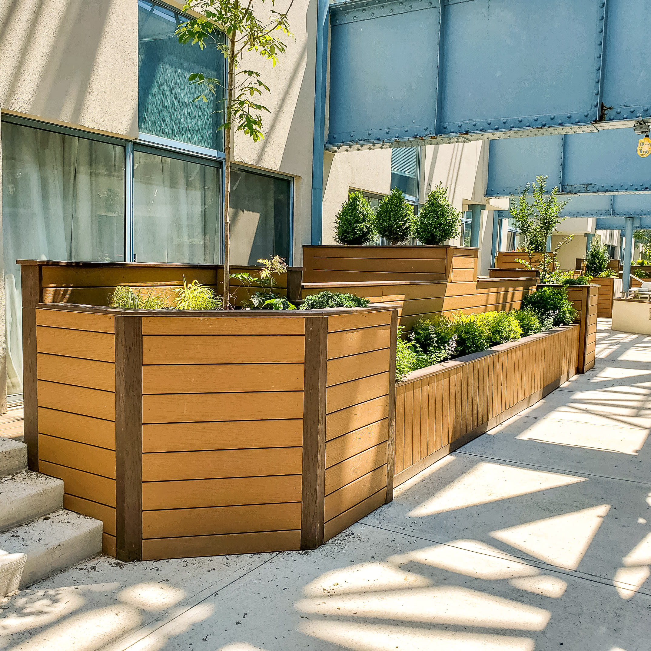 Use composite decking to make durable planter boxes alongside a deck or walkway. These flower boxes give the space a polished look made with low maintenance, long-lasting material.