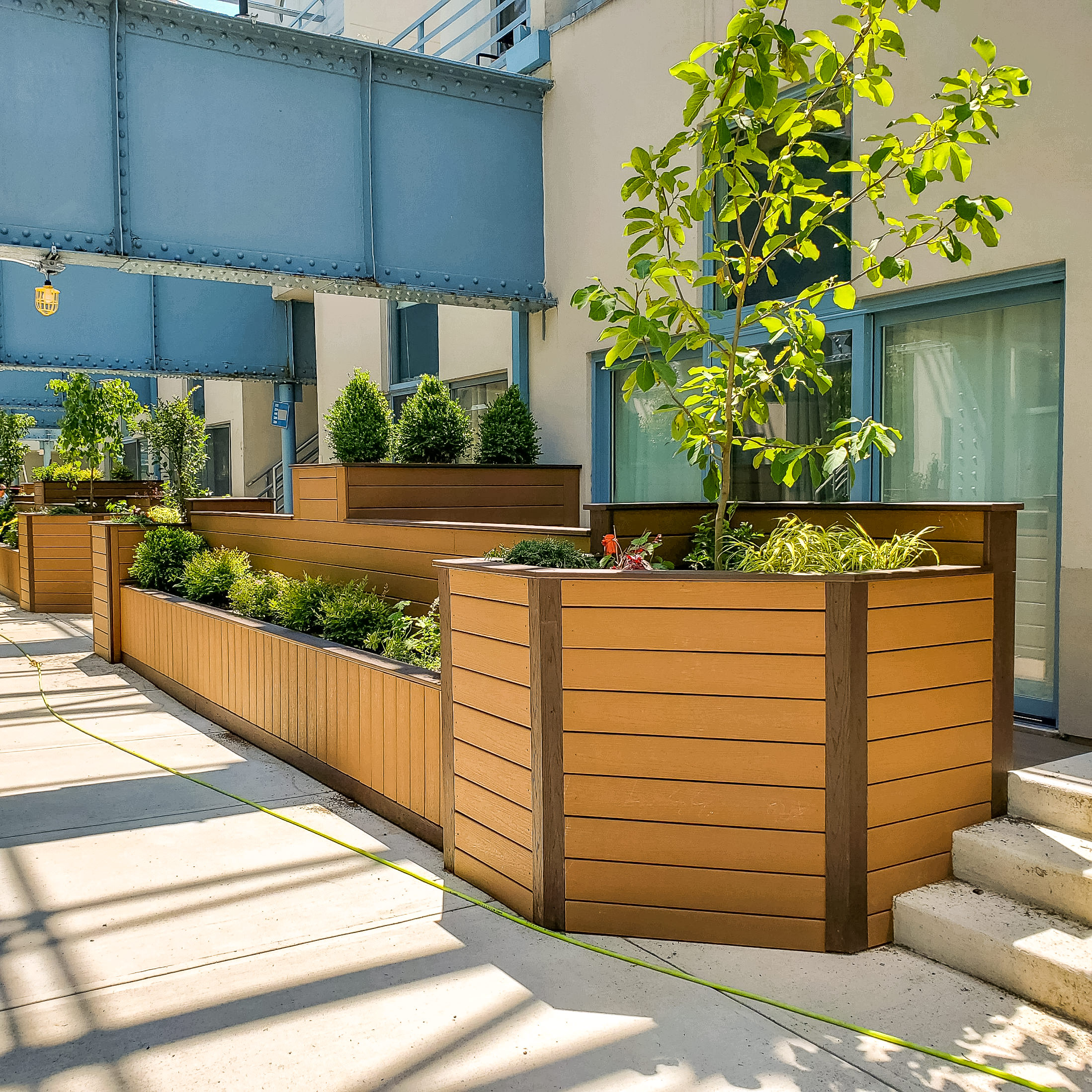 Use composite decking to make durable planter boxes alongside a deck or walkway. These flower boxes give the space a polished look made with low maintenance, long-lasting material.