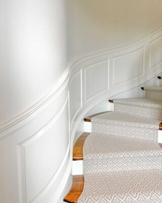 Staircase with custom curved wainscoting